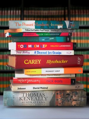 AustLit is one of the longest running digital humanities projects in Australia. Image: Andrew Yeo. A stack of around a dozen Australian novels, with their spines showing.